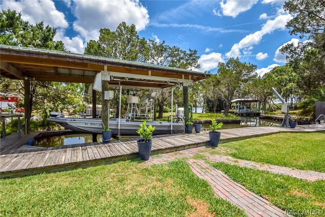 view of community with a boat dock, a water view, and a lawn