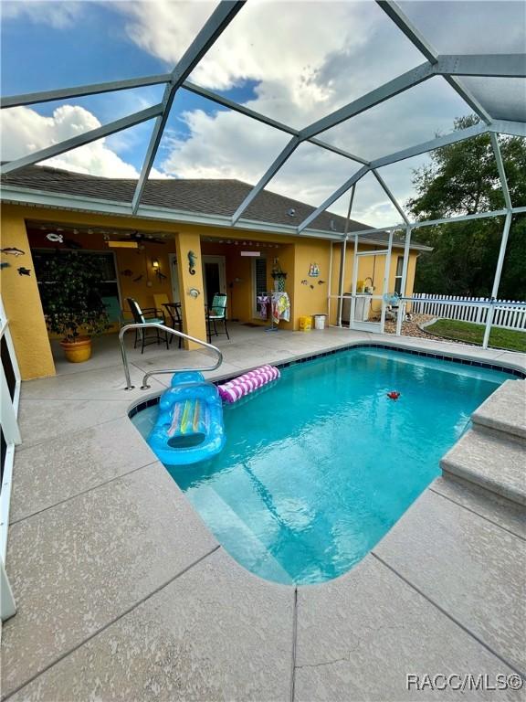 3495 W Wilburton Dr, Citrus Springs, FL 34433 - outdoor pool with a patio, a ceiling fan, and glass enclosure