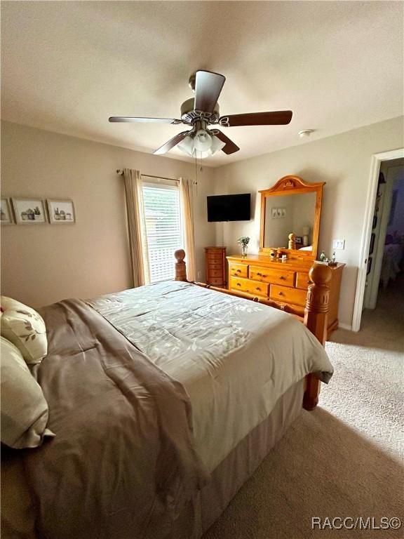3495 W Wilburton Dr, Citrus Springs, FL 34433 - bedroom featuring light carpet and a ceiling fan