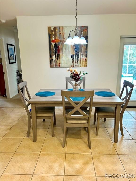 3495 W Wilburton Dr, Citrus Springs, FL 34433 - dining area featuring light tile patterned floors and a chandelier