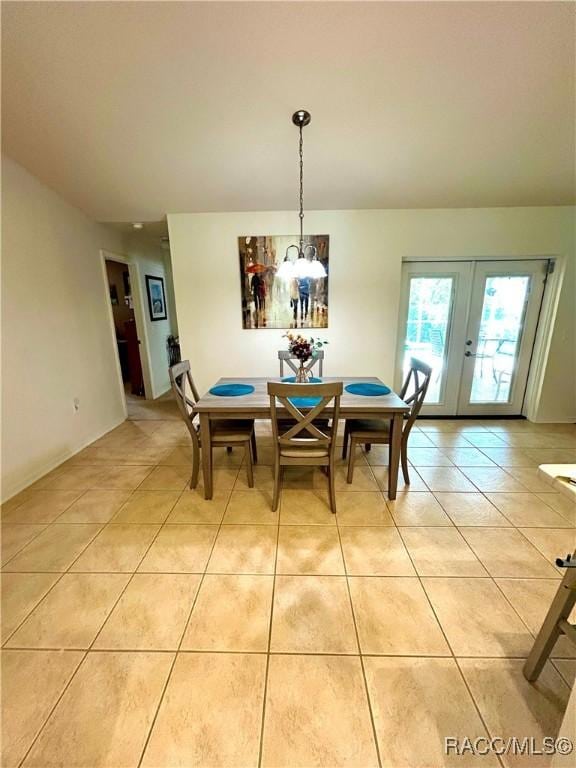 3495 W Wilburton Dr, Citrus Springs, FL 34433 - dining space featuring light tile patterned floors, french doors, and a chandelier