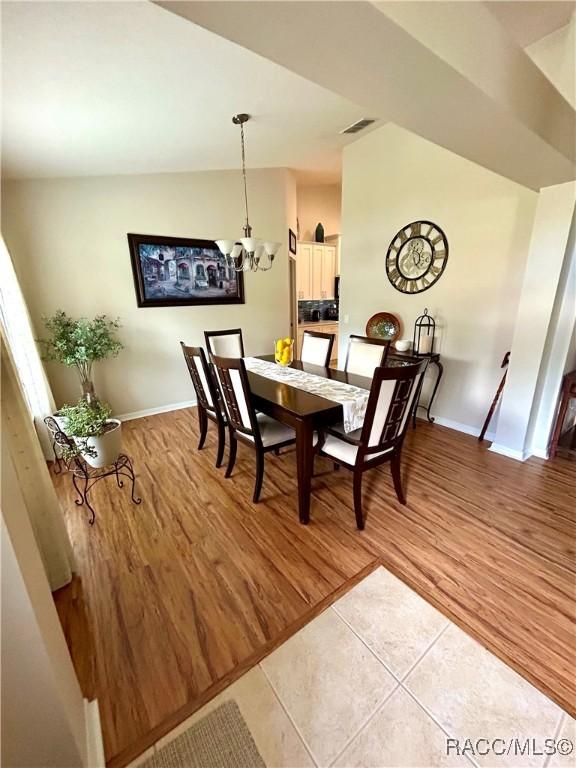 3495 W Wilburton Dr, Citrus Springs, FL 34433 - dining room with a chandelier and light wood-type flooring