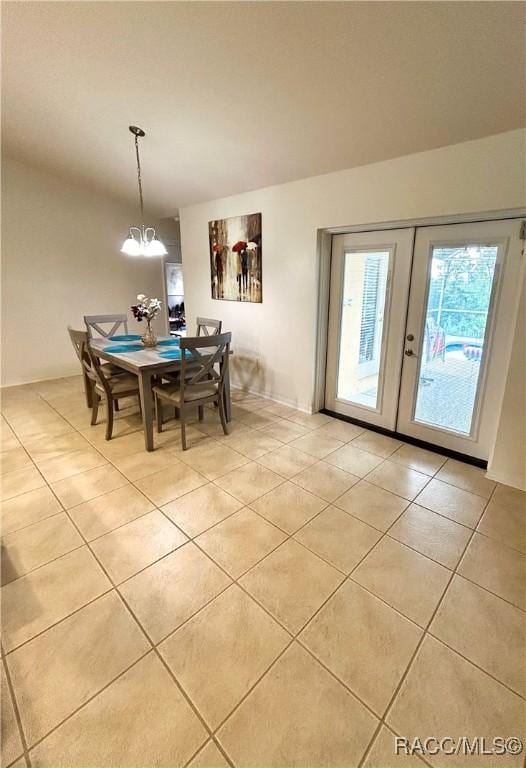 3495 W Wilburton Dr, Citrus Springs, FL 34433 - dining space featuring light tile patterned floors, french doors, and a chandelier
