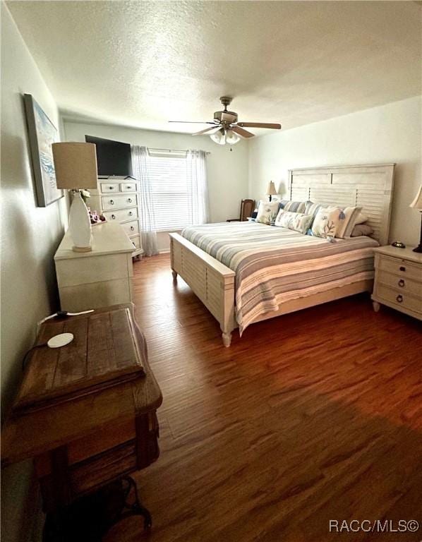 3495 W Wilburton Dr, Citrus Springs, FL 34433 - bedroom with dark wood-type flooring, ceiling fan, and a textured ceiling