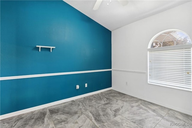 empty room with ceiling fan and lofted ceiling