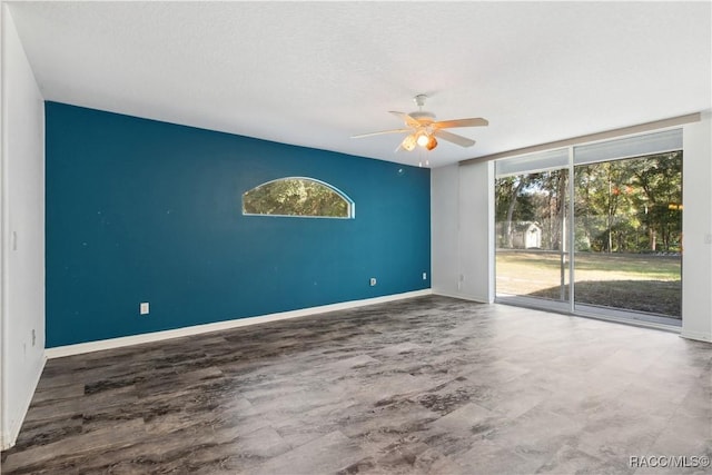 empty room featuring ceiling fan and a textured ceiling