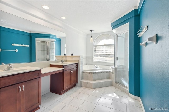 bathroom featuring tile patterned flooring, vanity, a textured ceiling, and plus walk in shower