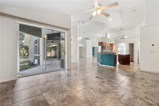 unfurnished living room with high vaulted ceiling