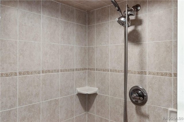 bathroom with a tile shower