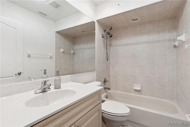 full bathroom with vanity, toilet, and tiled shower / bath