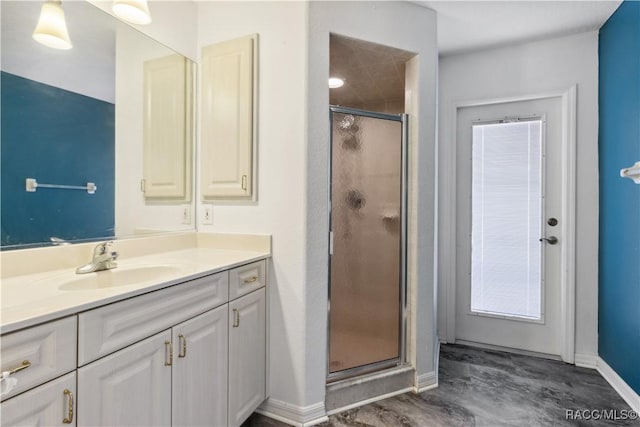 bathroom featuring vanity and an enclosed shower