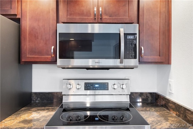 kitchen featuring appliances with stainless steel finishes and dark stone counters