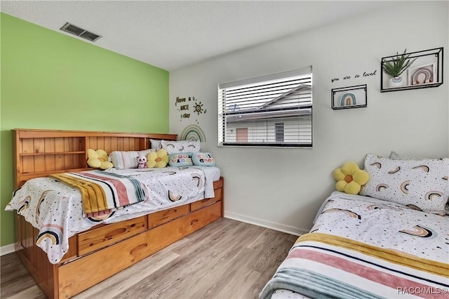 4055 N Little Hawk Pt, Crystal River, FL 34428 - bedroom with wood finished floors, baseboards, and visible vents