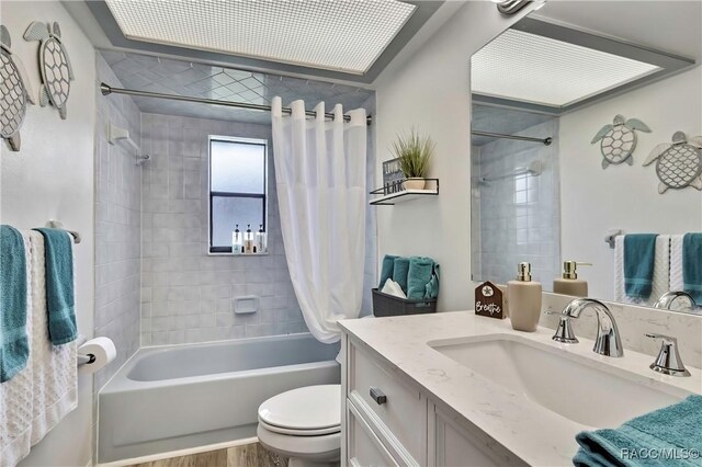 4055 N Little Hawk Pt, Crystal River, FL 34428 - bathroom with toilet, shower / bath combo with shower curtain, vanity, and wood finished floors