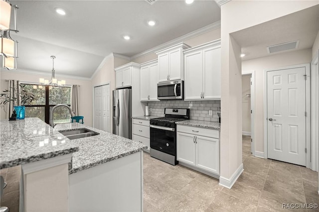 3153 N Chandler Dr, Hernando, FL 34442 - kitchen with stainless steel appliances, crown molding, lofted ceiling, tasteful backsplash, and white cabinetry
