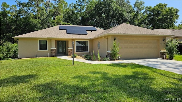 3153 N Chandler Dr, Hernando, FL 34442 - view of front of house with stucco siding, a garage, solar panels, a front yard, and driveway