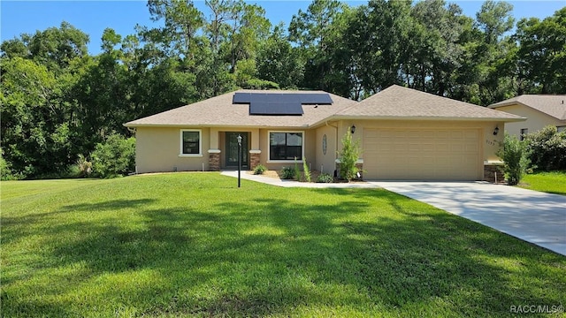 3153 N Chandler Dr, Hernando, FL 34442 - view of front of house featuring a garage, solar panels, stucco siding, driveway, and a front lawn