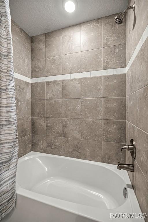 3153 N Chandler Dr, Hernando, FL 34442 - full bath featuring shower / bathtub combination with curtain and a textured ceiling