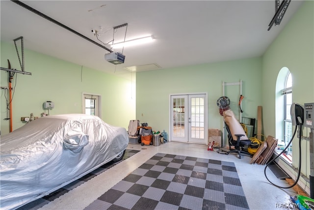 garage with a garage door opener and french doors