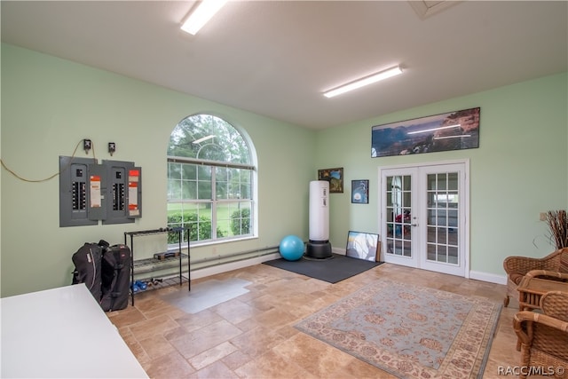 workout room featuring electric panel and french doors