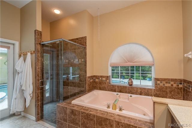 bathroom with tile patterned flooring and independent shower and bath