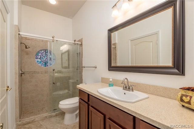 bathroom featuring toilet, vanity, and walk in shower