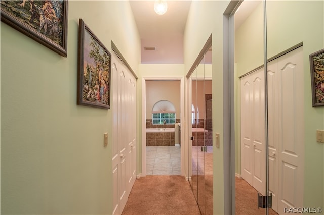 hallway with light carpet