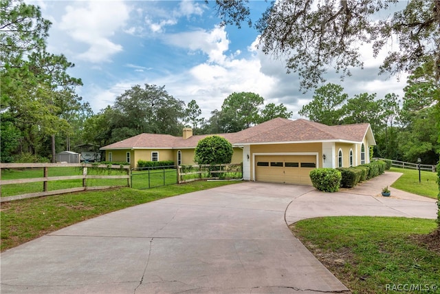 view of front facade with a garage and a front lawn