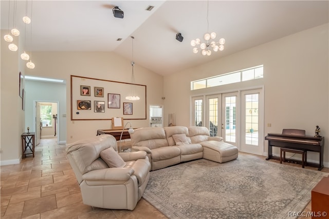 living room with an inviting chandelier, high vaulted ceiling, and plenty of natural light