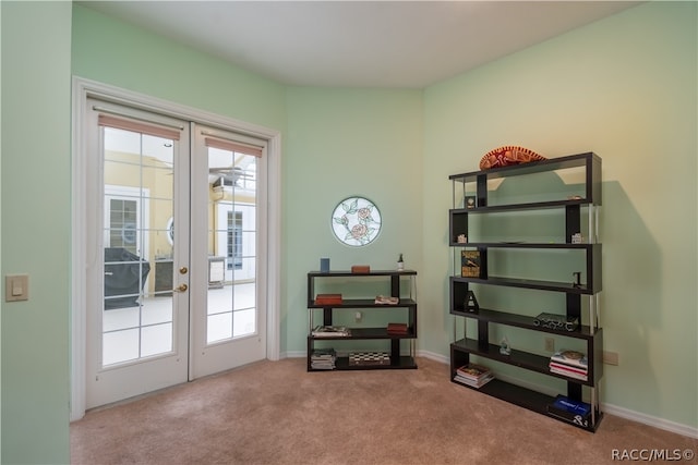 entryway with light carpet and french doors