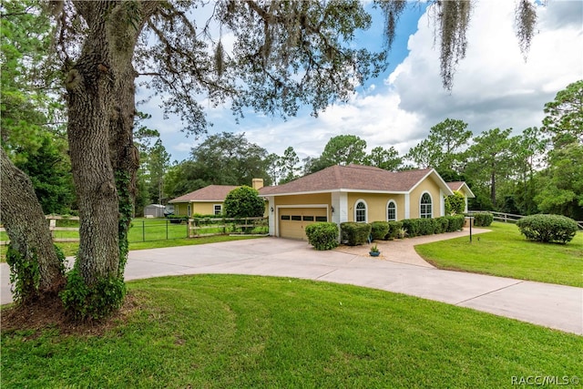 view of front of house featuring a front yard and a garage