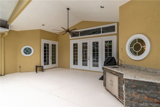 view of patio / terrace with ceiling fan, exterior kitchen, sink, and french doors