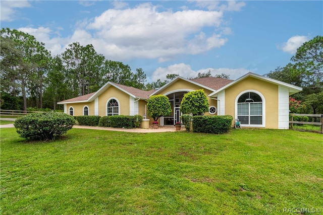 single story home featuring central air condition unit and a front yard