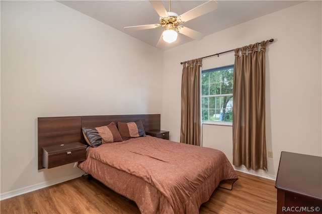 bedroom featuring ceiling fan and light hardwood / wood-style floors