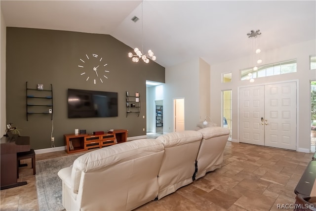 living room with high vaulted ceiling and a chandelier