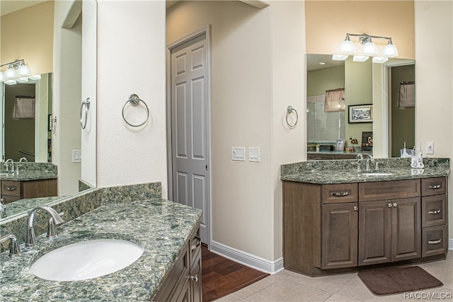 bathroom featuring a shower, hardwood / wood-style floors, and vanity