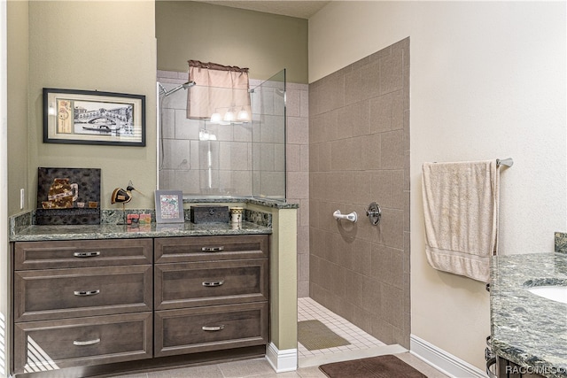 bathroom featuring tile patterned floors, vanity, and tiled shower