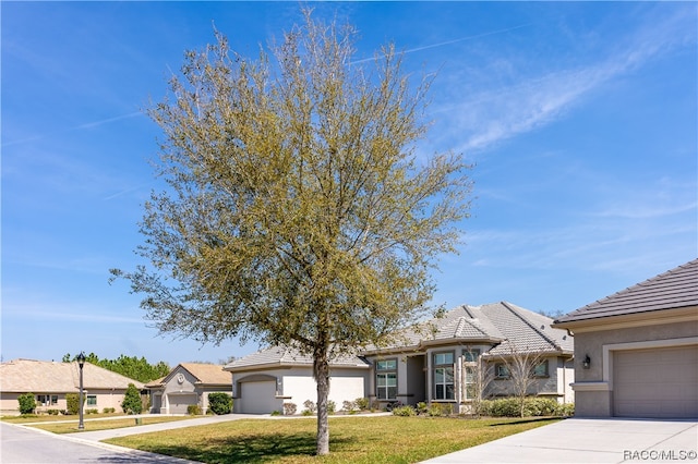 ranch-style house with a garage and a front lawn