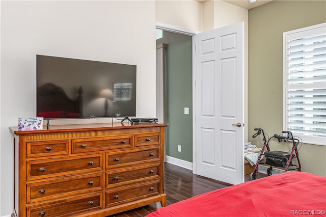 bedroom with dark wood-type flooring