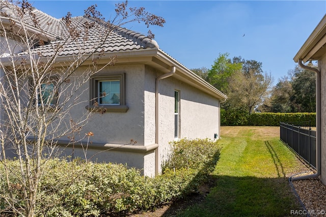 view of home's exterior with a lawn