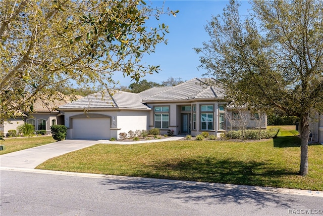 view of front of property featuring a garage and a front lawn