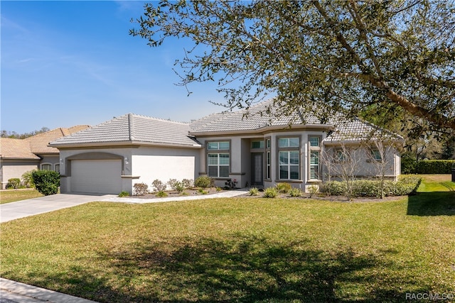 view of front of house with a garage and a front lawn