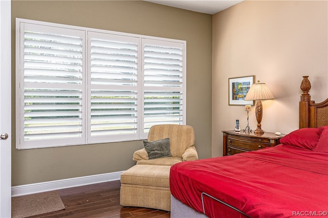 bedroom featuring dark hardwood / wood-style floors and multiple windows