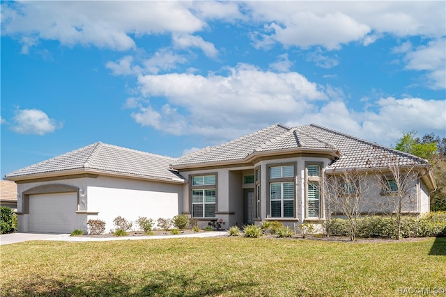 view of front of house featuring a front yard and a garage