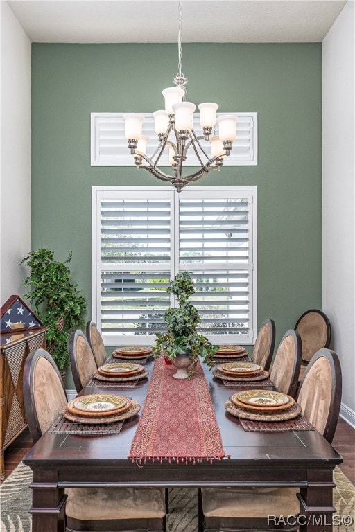 dining room featuring hardwood / wood-style flooring and a notable chandelier