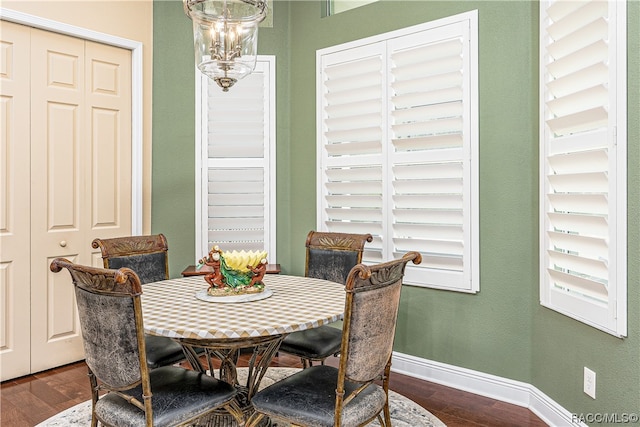 dining room featuring dark hardwood / wood-style floors and a notable chandelier