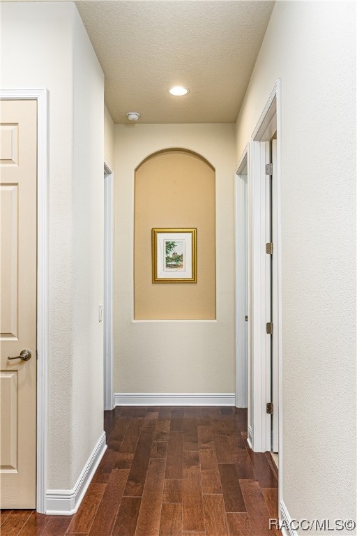 hall with dark hardwood / wood-style floors