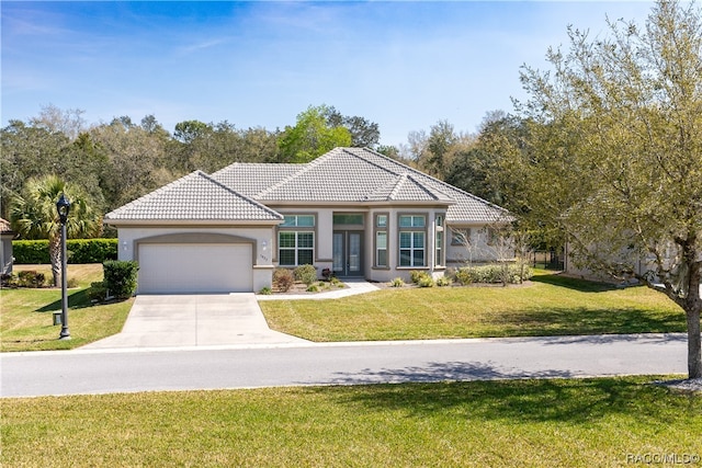 view of front of property with a front lawn and a garage