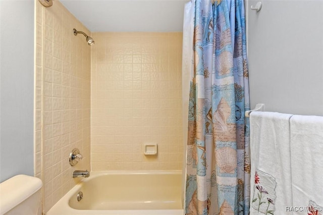 bathroom with shower / bath combination with curtain and toilet