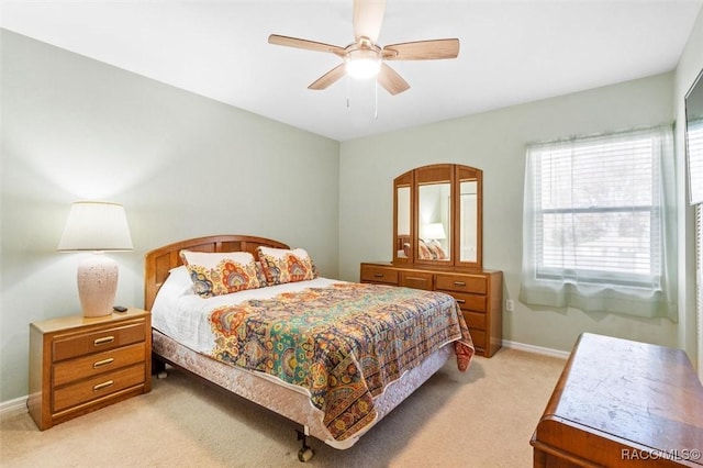 bedroom with light carpet and ceiling fan